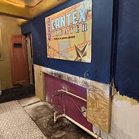 The old LanTex sign propped against a painted lobby wall